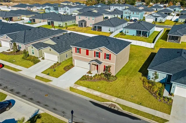an aerial view of residential houses with outdoor space