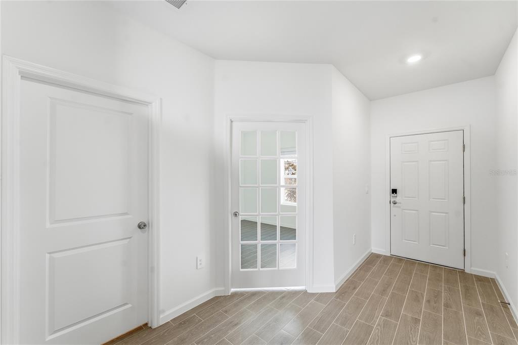 6680 Southwest 89th Loop Ocala, FL 34476 - Photo 8 of 39 a view of empty room with wooden floor and entryway
