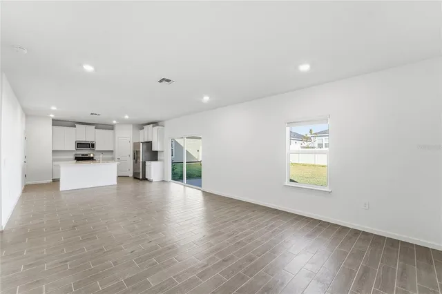 a view of a kitchen with a sink and a refrigerator