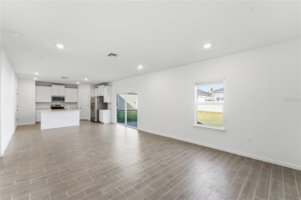 6680 Southwest 89th Loop Ocala, FL 34476 - Photo 9 of 39 a view of a kitchen with a sink and a refrigerator
