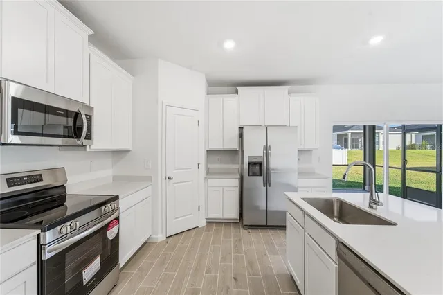 a kitchen that has a sink and a stove top oven
