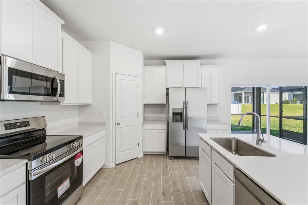 6680 Southwest 89th Loop Ocala, FL 34476 - Photo 10 of 39 a kitchen that has a sink and a stove top oven