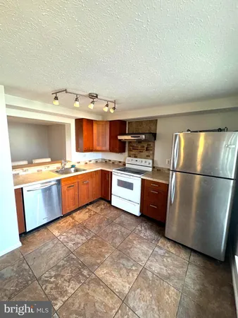 a kitchen with stainless steel appliances a refrigerator and a sink
