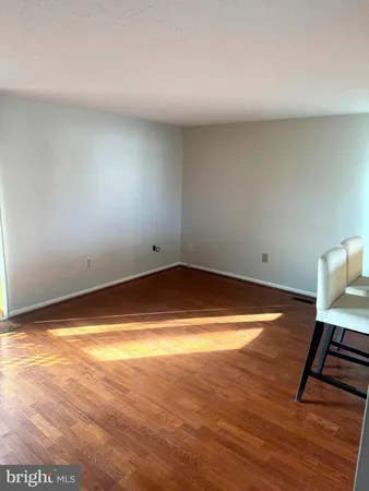 a view of room with wooden floor and chair