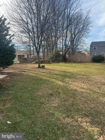 a swimming pool with outdoor seating and yard