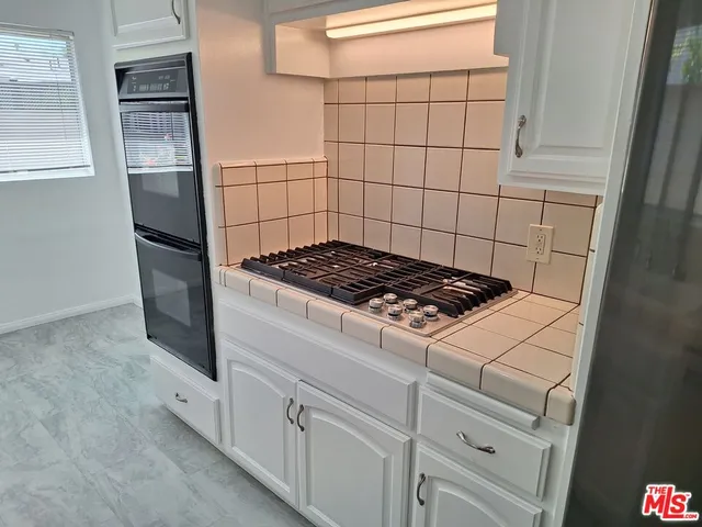 a kitchen with a stove and a refrigerator