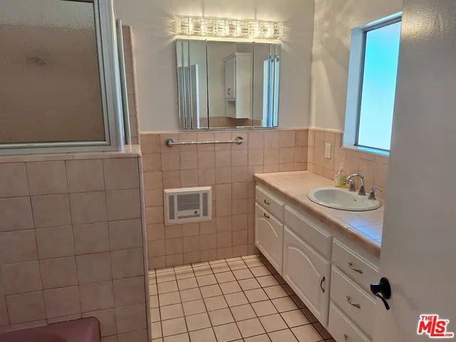 a bathroom with a sink a vanity and a mirror