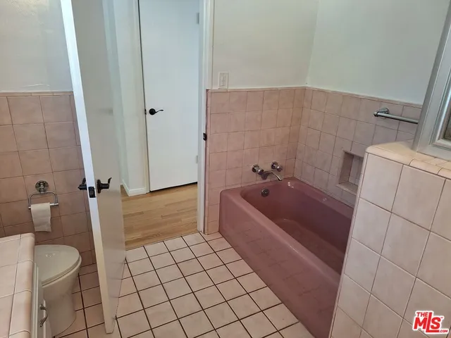a bathroom with a bathtub and toilet