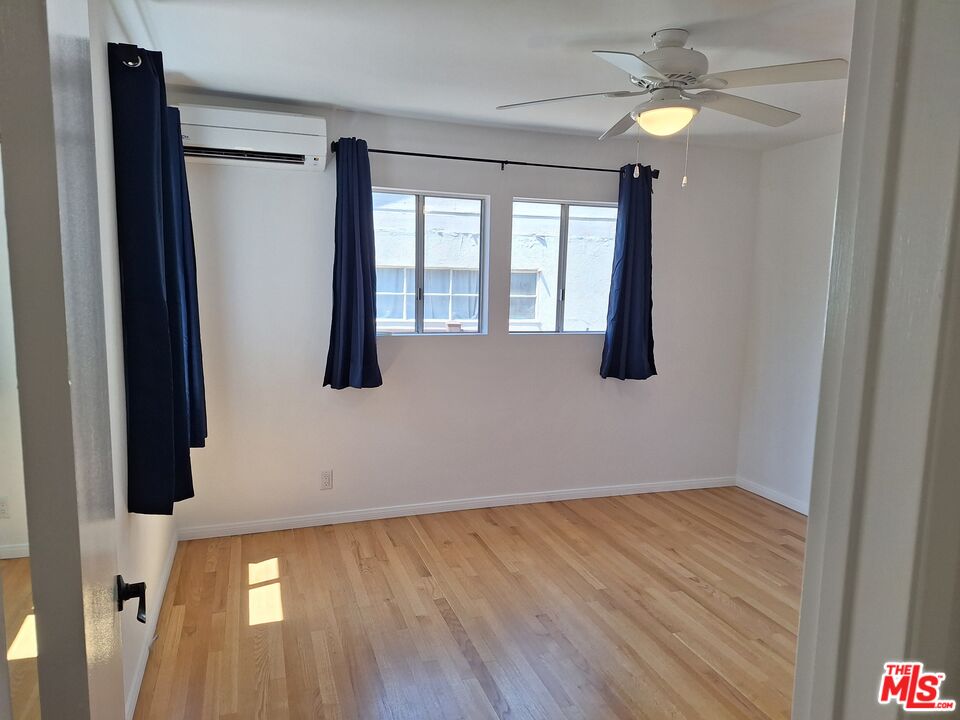 6446 Riggs Place Los Angeles, CA 90045 - Photo 16 of 22 wooden floor in an empty room with a window