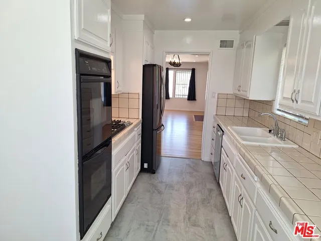 a kitchen with a sink stove and refrigerator