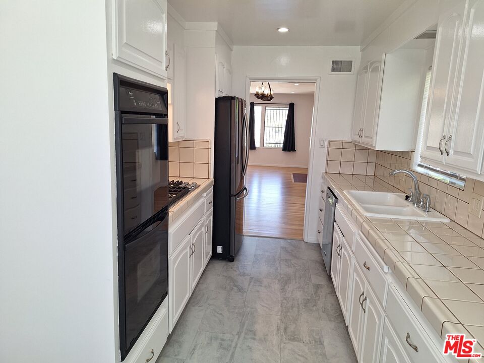 6446 Riggs Place Los Angeles, CA 90045 - Photo 8 of 22 a kitchen with a sink stove and refrigerator