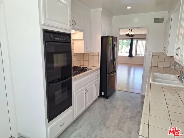 a kitchen with stainless steel appliances a refrigerator and a stove