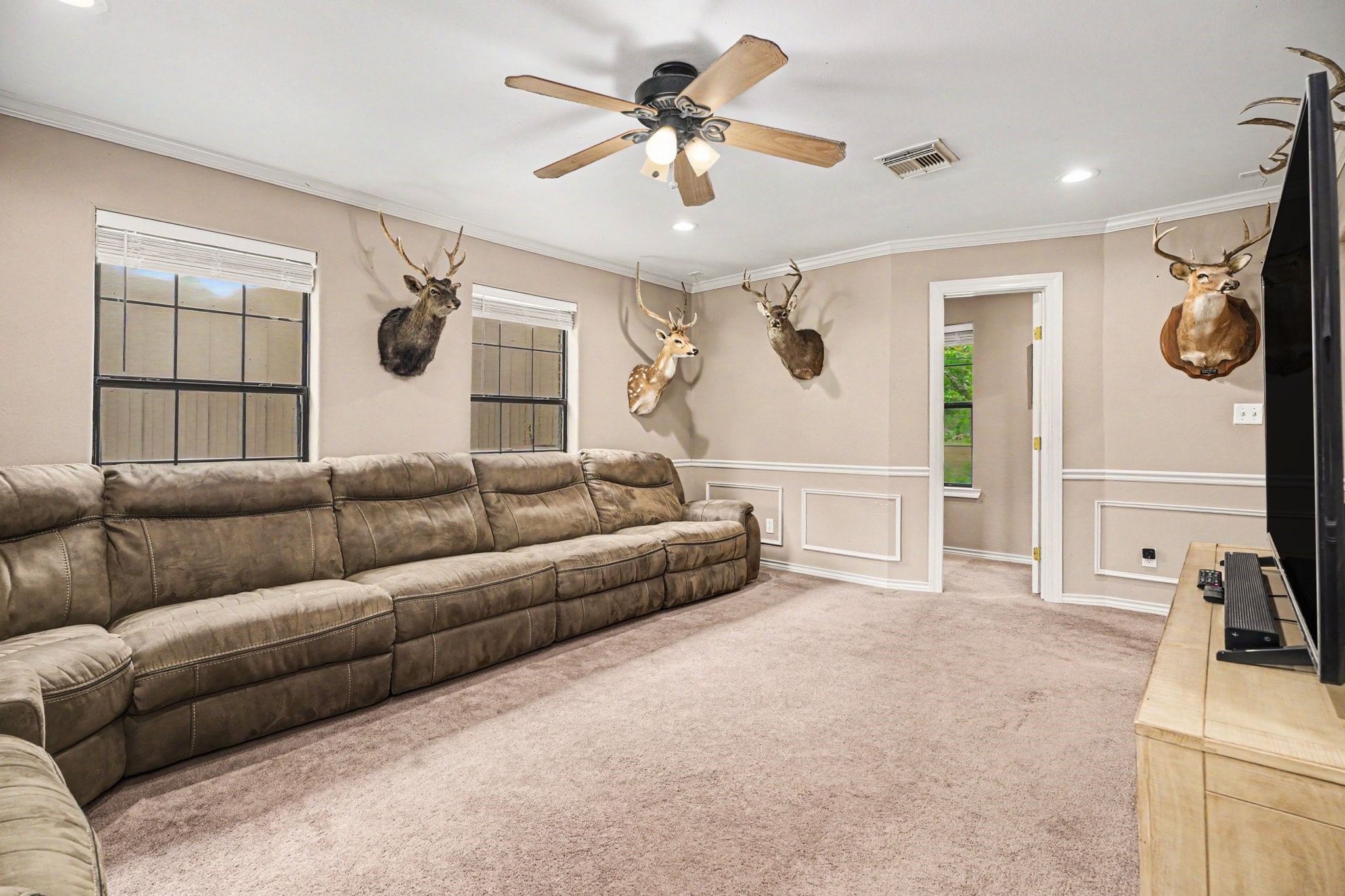 5104 Avenue R Santa Fe, TX 77510 - Photo 6 of 35 Cozy, carpeted family room featuring ample natural light, with a small office located right off it.
