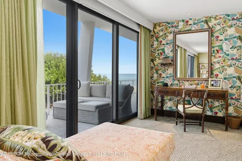 a bedroom with a bed and large window