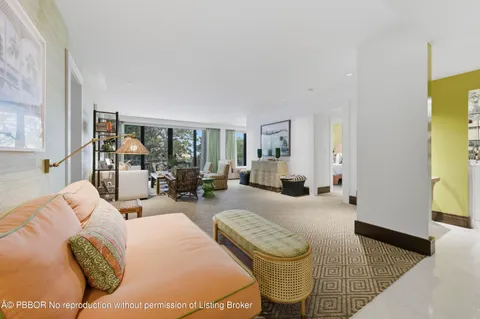 a bedroom with furniture and a large window