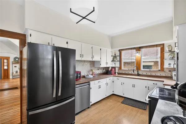 a kitchen with stainless steel appliances a refrigerator sink and cabinets