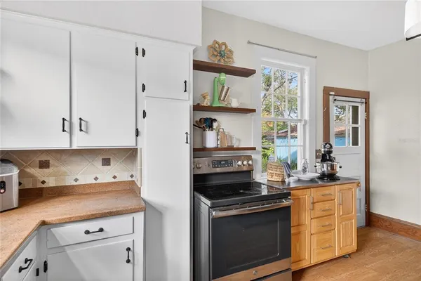 a kitchen with stainless steel appliances white cabinets and a stove