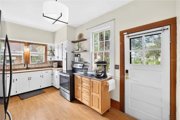 a kitchen with white cabinets and white appliances