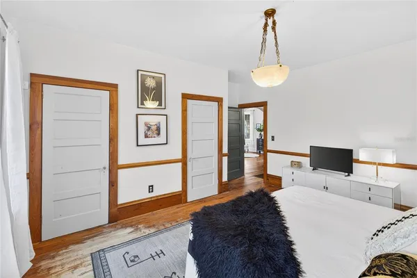 a bedroom with a bed and a chandelier