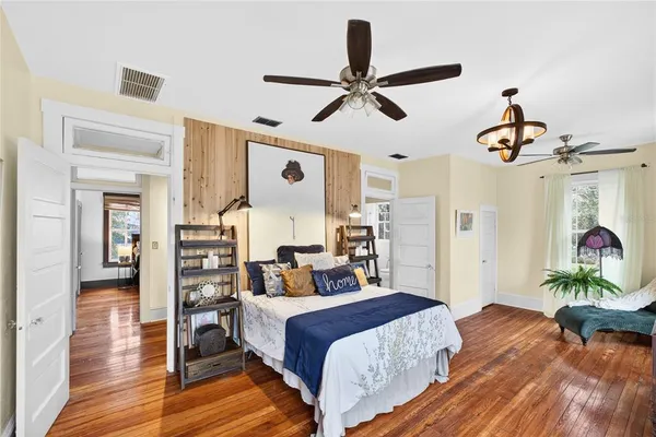 a bedroom with a bed and a chandelier