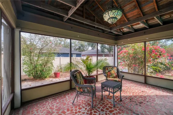 a dining room with furniture a chandelier and a rug