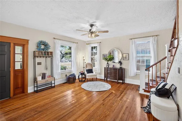 a living room with fireplace furniture and a wooden floor