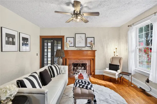 a living room with furniture and a fireplace
