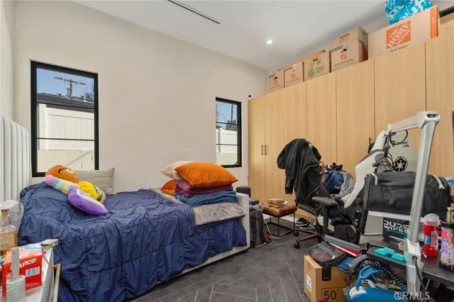a bedroom with two beds and a window