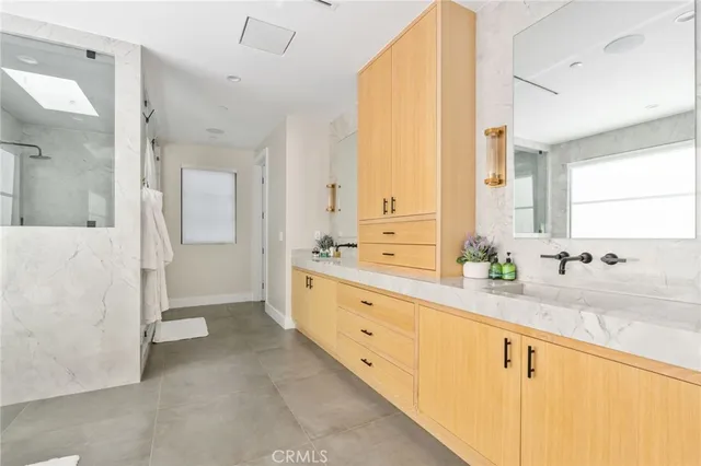 a spacious bathroom with a granite countertop sink mirror and a