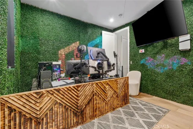 a view of a patio with table and chairs potted plants with floor to ceiling window