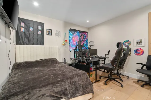 a bedroom with a bed and wooden floor