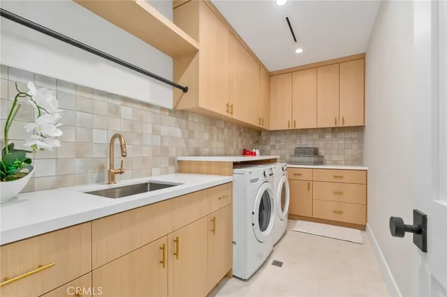 a kitchen with cabinets appliances a sink and a counter top space