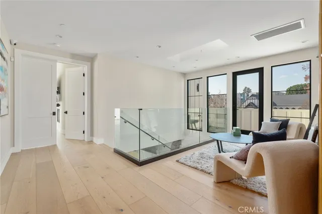 a living room with furniture and a floor to ceiling window