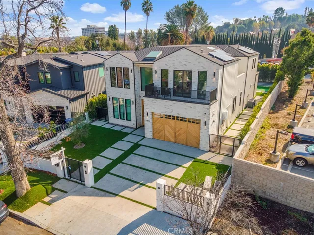 a aerial view of a house with a yard patio and furniture