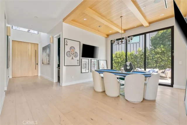 a living room with large windows and furniture