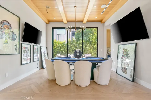 a dining room with furniture floor to ceiling window and flat screen tv