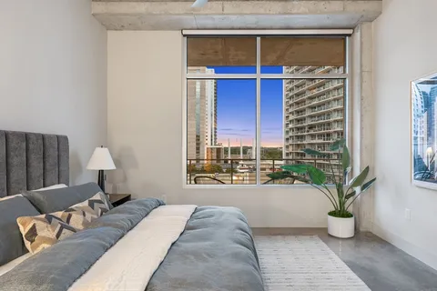a bedroom with a bed and a window