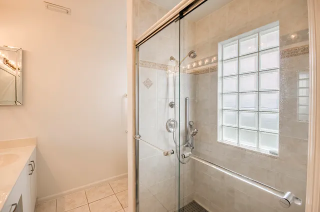 a bathroom with a glass shower door