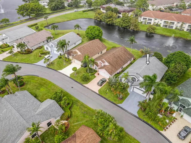 an aerial view of a house with a garden and lake view