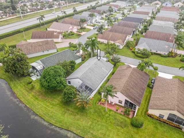 an aerial view of a house with a garden and swimming pool
