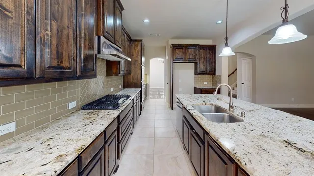 a kitchen with a stove and a sink