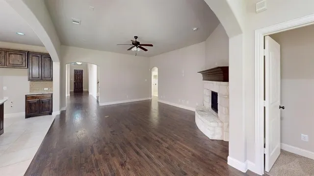 a view of a hallway with wooden floor and a fireplace