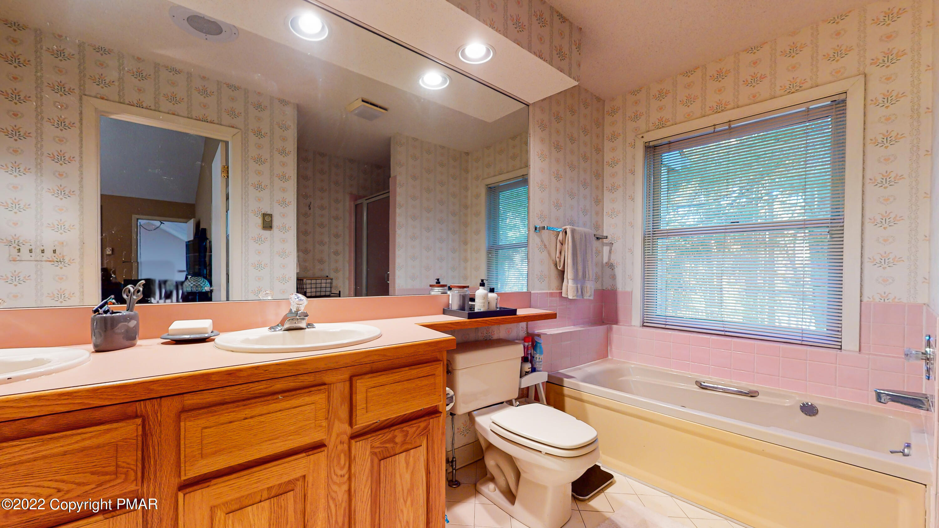 2169 Oak Hill Drive Canadensis, PA 18325 - Photo 20 of 40 a bathroom with a double vanity sink a mirror and a bathtub