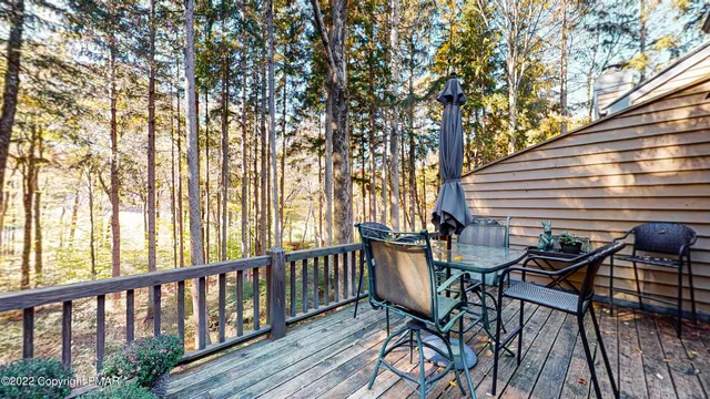 a view of balcony with chairs and wooden fence