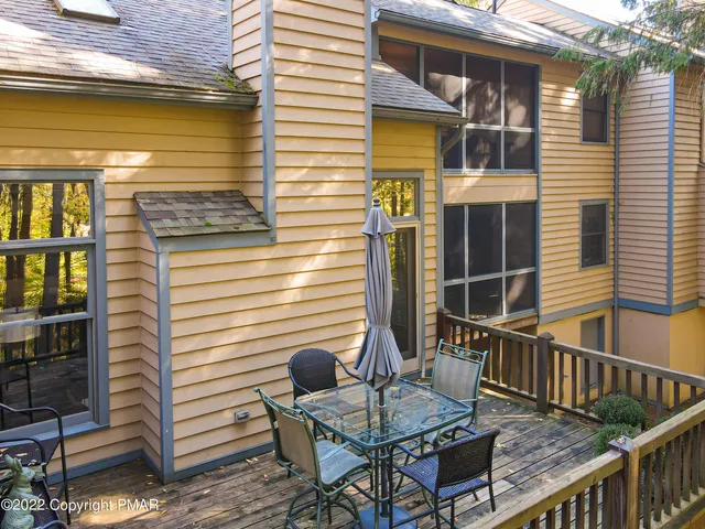 a balcony with table and chairs