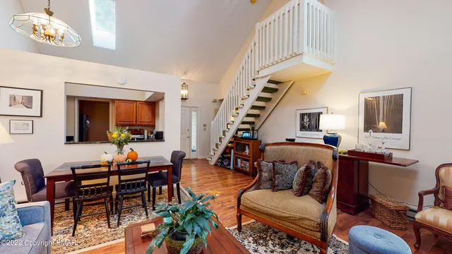 a living room with furniture and a chandelier
