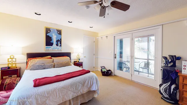 a bedroom with a bed and a large window