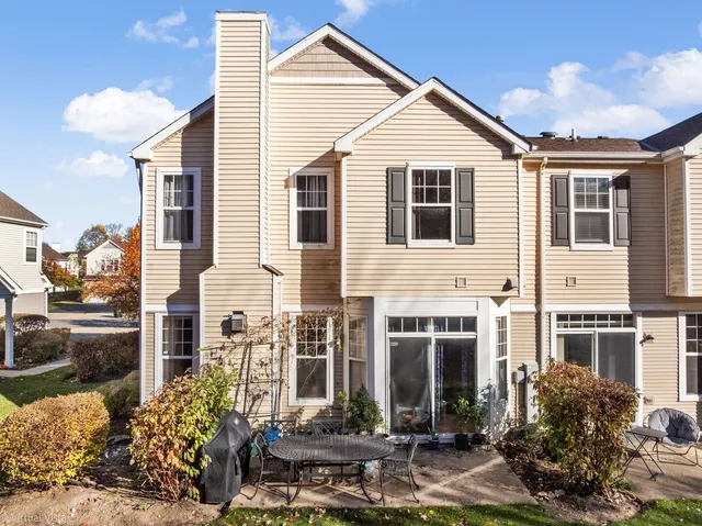 a front view of a house with sitting area