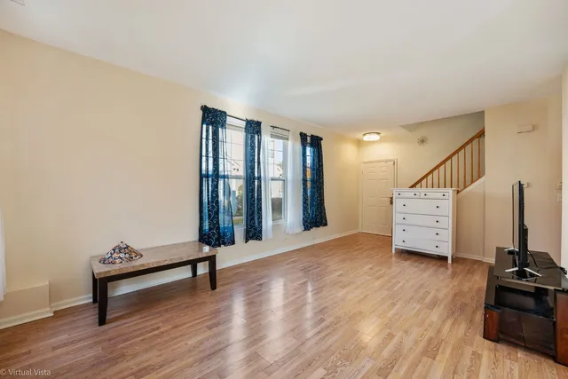 a view of a room with wooden floor and furniture