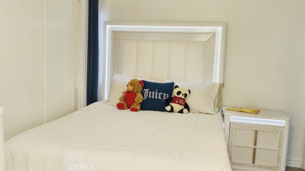 26250 9th Street, Unit 131 Highland, CA 92346 - Photo 11 of 15 a bedroom with a bed and hallway